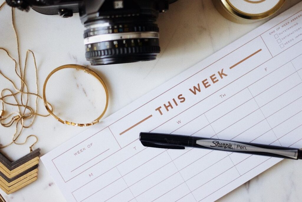 Pen and open notebook on a desk in soft natural light, representing the deliberate clarity that becomes difficult for high-functioning professionals experiencing decision fatigue