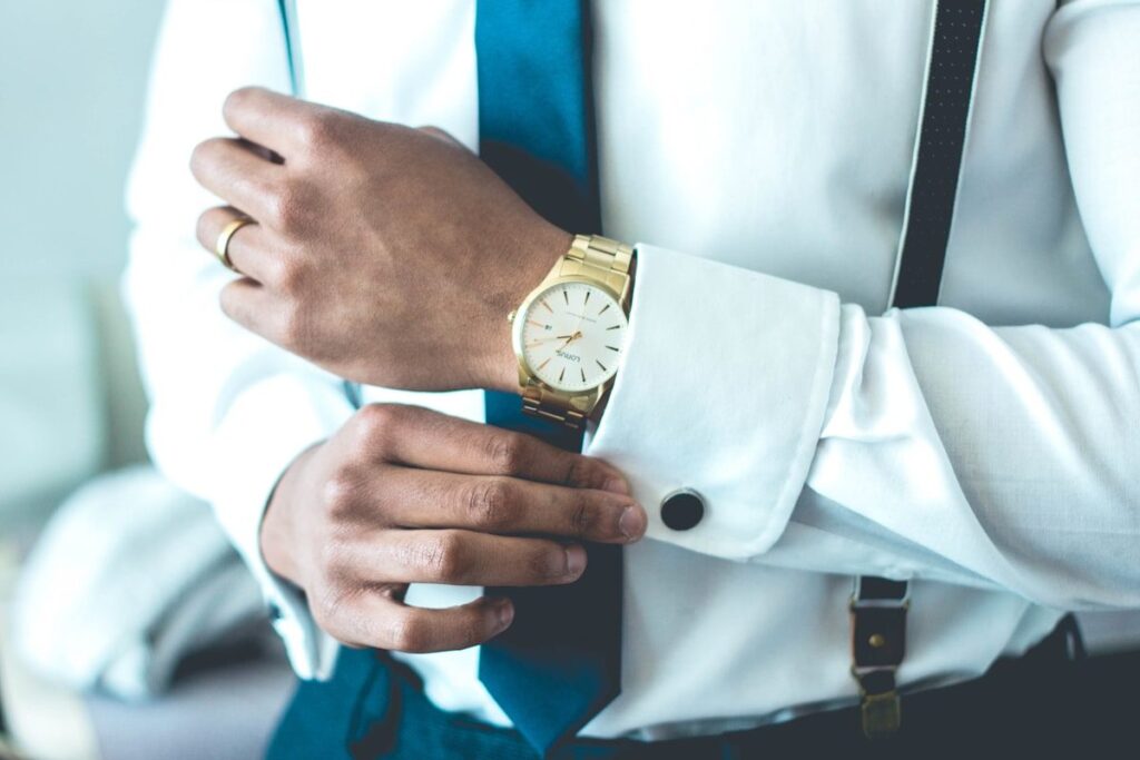 Close-up of a professional wearing a white shirt and gold watch — representing the grounded, high-functioning individual who has reconnected with psychological presence