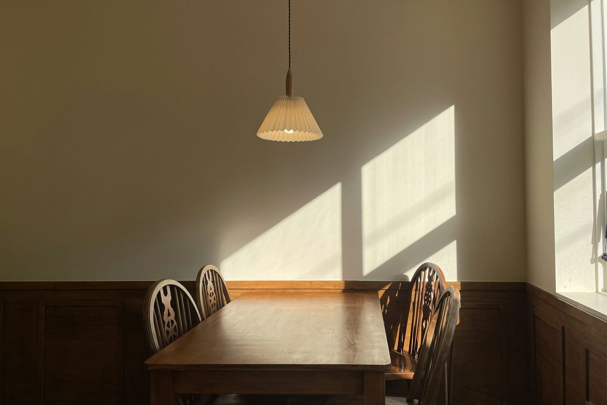 Warm morning sunlight on a simple wooden table, evoking calm, simplicity and nervous system regulation — Tidylodge Advanced-EMDR Intensives Singapore